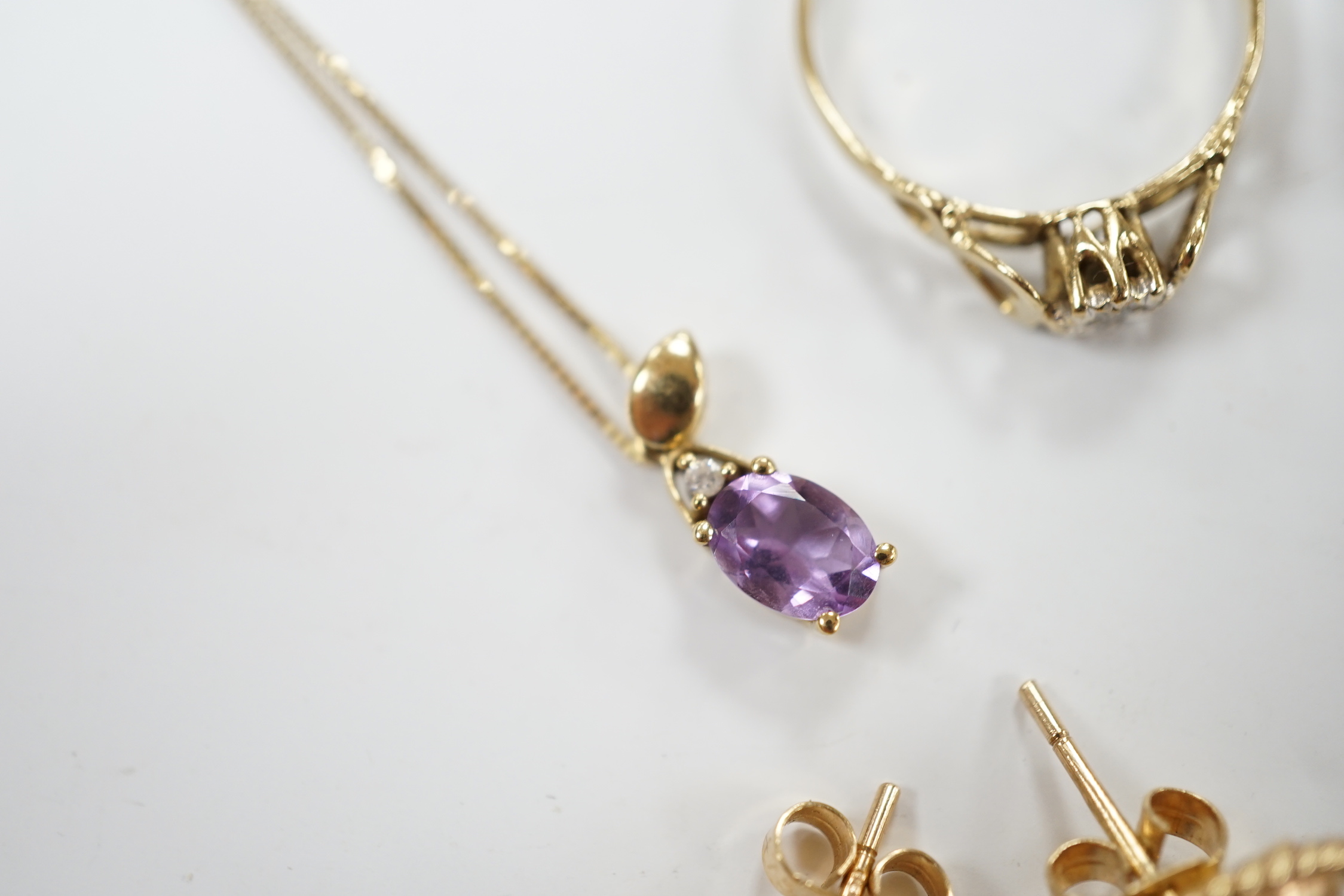 Two 9ct and gem set rings, including diamond chip and white opal, a 9ct and amethyst set pendant necklace, pair of 9ct gold and garnet earrings, a 9ct mounted cameo shell brooch and pair of matching earrings, gross weigh